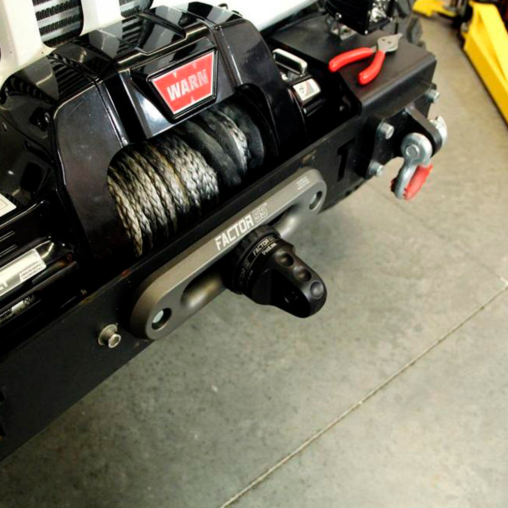 A close up of a truck with a Factor 55 Shackle Mount in Gray 00015-04 attached to it, featuring winch hooks.