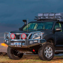 Load image into Gallery viewer, A black Old Man Emu Toyota Land Cruiser parked on a dirt road with a lifted suspension.