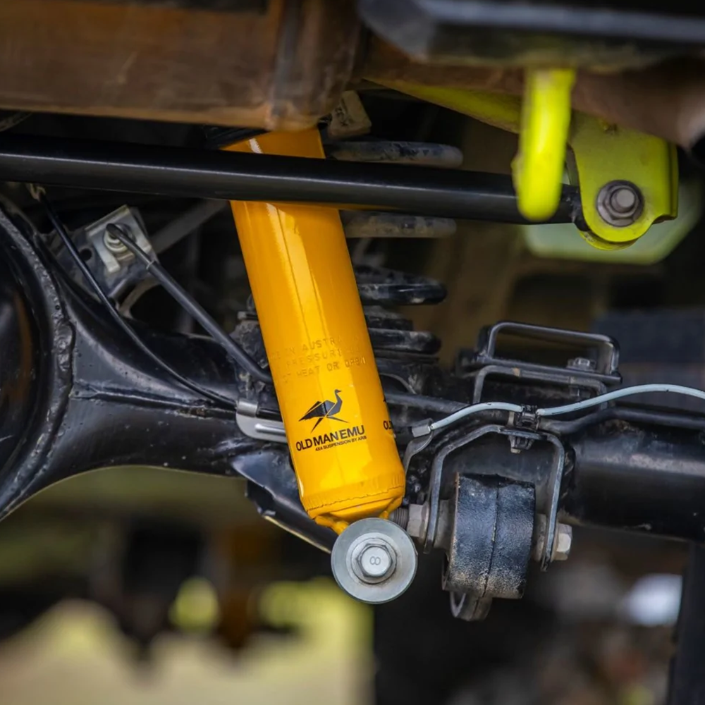 The rear suspension of a Jeep Wrangler utilizes the ARB Old Man Emu Rear Nitrocharger Sport 60155 for Suzuki Jimny (4th Gen) 4 Cylinder 1.5L Petrol Engine All Models and features compression valving by Old Man Emu.