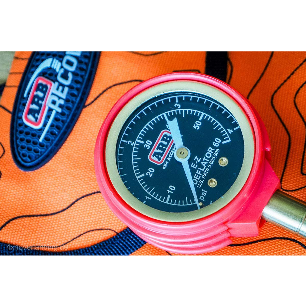 An ARB E-Z Deflator Tire Deflator ARB505 sits on top of a bag, allowing for accurate psi readings.