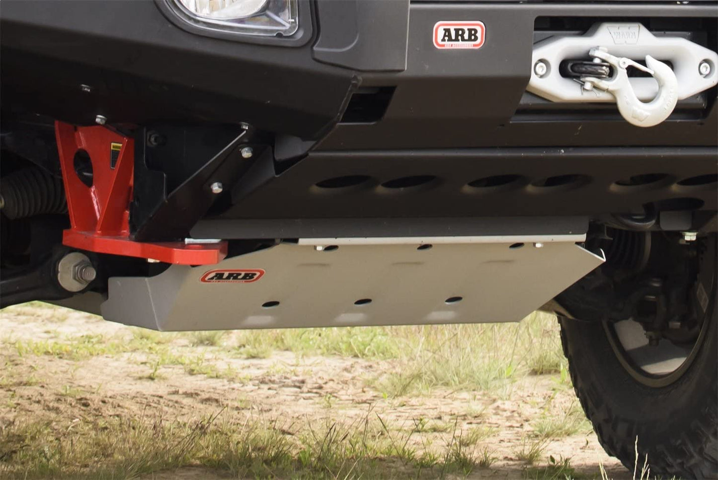 The front end of an ARB Toyota Tacoma (2005-2023) truck with a red bumper and 4WD drivetrain.