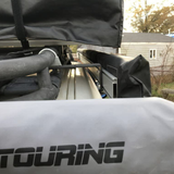 The back of a truck with the ARB Universal Awning Bracket for Most Roof Racks OS850 on it, equipped with roof bars for off-road adventures.