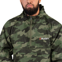 Load image into Gallery viewer, A man wearing the Mudify Embroidered Mudify Packable Jacket, wind and rain resistant.