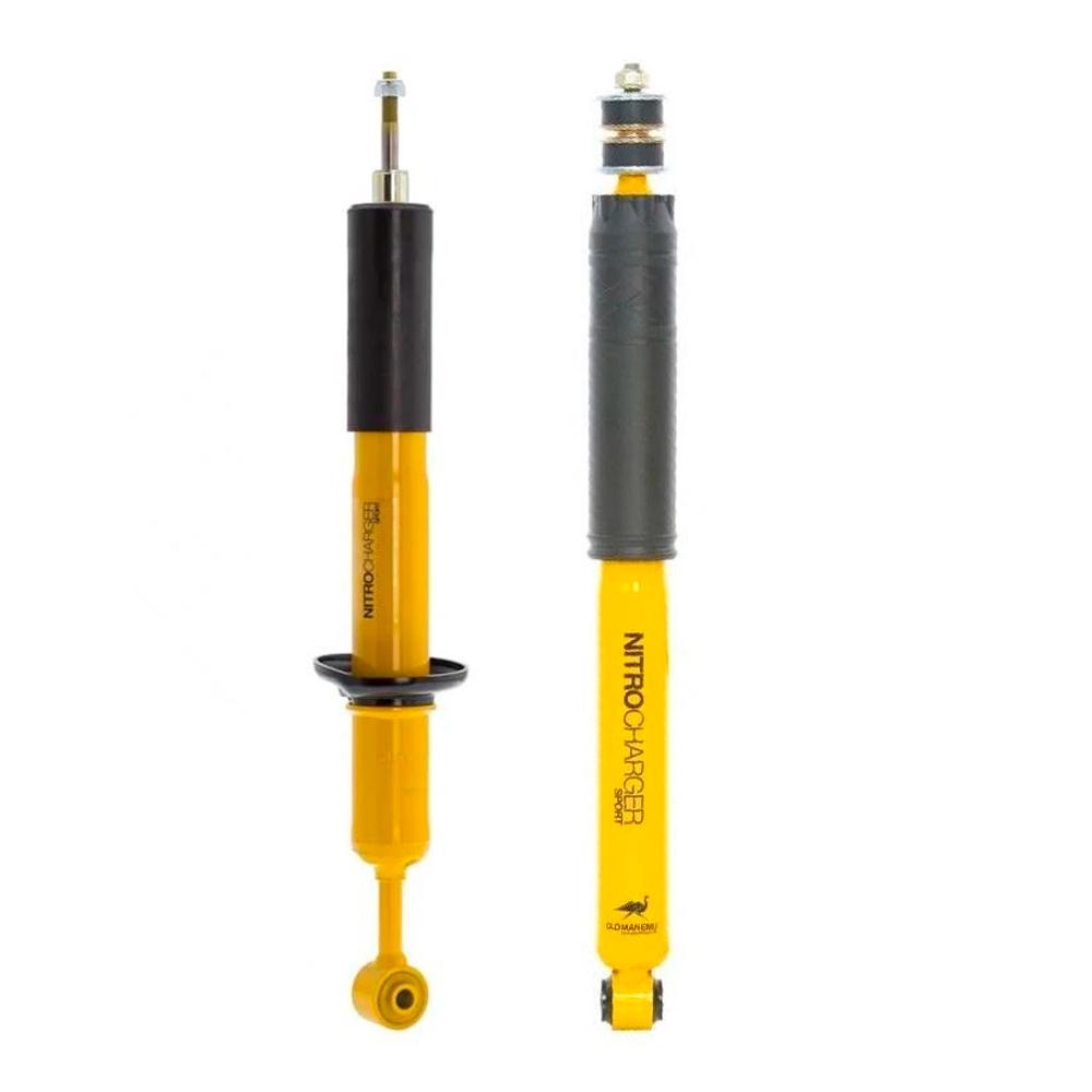A pair of yellow and black Old Man Emu shock absorbers with compression valving on a white background.