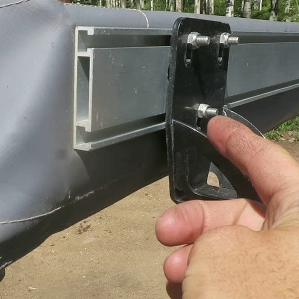 A person is holding a piece of metal on the side of a canoe equipped with ARB Universal Awning Bracket for Most Roof Racks OS850.