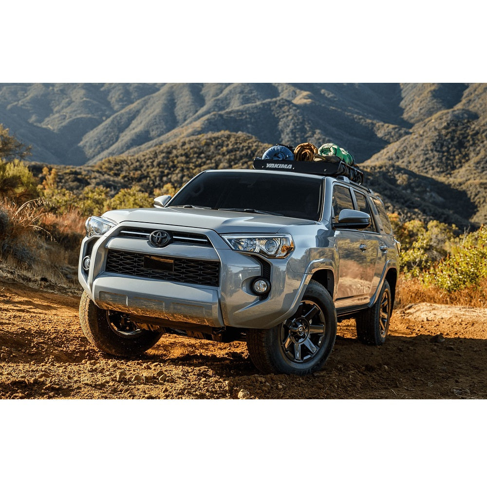 The 2019 Toyota 4Runner, equipped with the ARB Under Vehicle Skid Plates System with kinetic (KDSS) 5421110 from ARB, is parked on a dirt road.