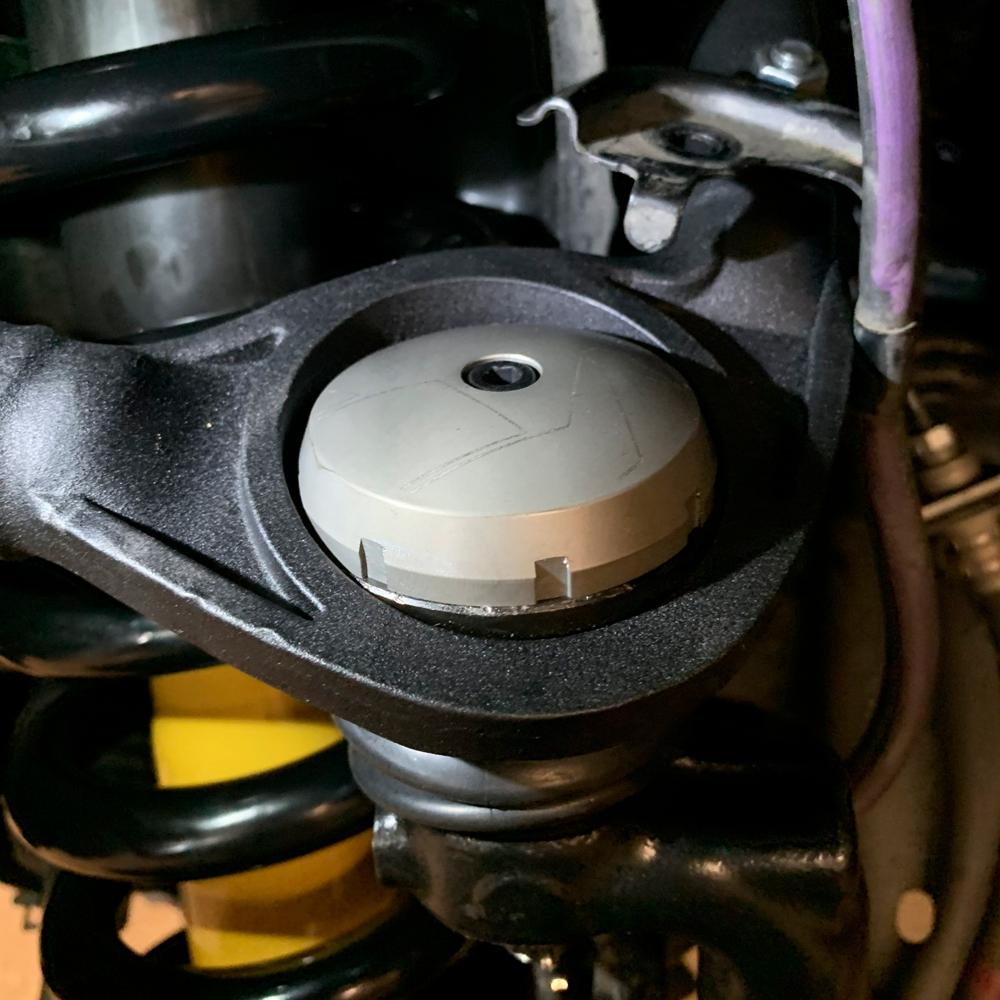 A close up of an Old Man Emu motorcycle tire with suspension lift.