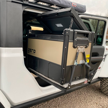Load image into Gallery viewer, A durable ARB Jeep Wrangler with versatile capacity, featuring an ARB Zero 73 Quart Dual Zone Portable Fridge Freezer 10802692 in the back seat.