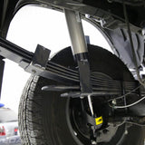 A close up of the suspension system on a Toyota 4Runner featuring the ARB Old Man Emu Leaf Spring U-Bolt OMEU53B components.