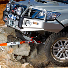 Load image into Gallery viewer, A Toyota Tacoma equipped with ARB vehicle recovery gear is securely parked on a rock using a snatch block strap from ARB715LB.
