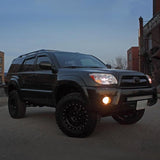 A black Old Man Emu 4Runner with the OME BP-51 2.5 - 3 inch Lift Kit for 4Runner (03-09) adjustable damping and suspension system is parked in a parking lot.