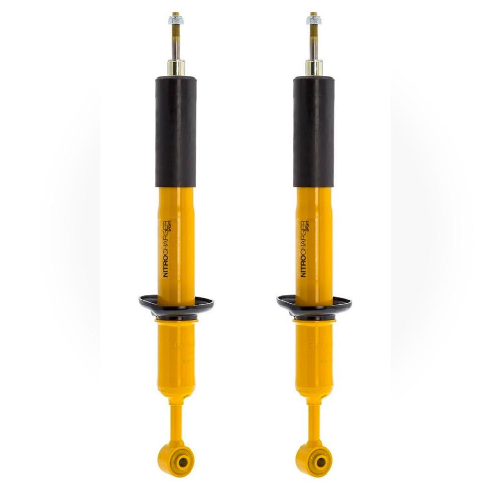 A pair of Old Man Emu yellow shock absorbers featuring heavy gauge reserve tubes and high-quality oil on a white background.