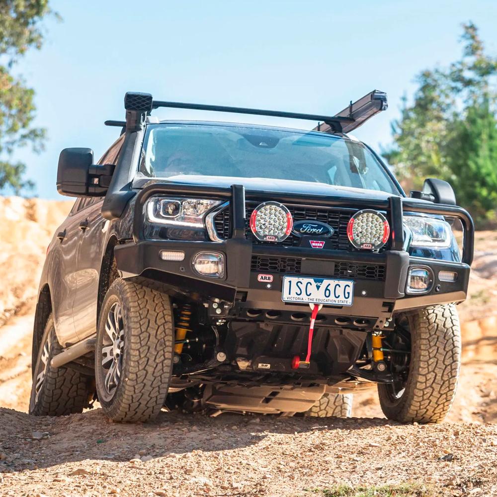A Ford Ranger equipped with an ARB Air Fitting (R1 5 1/8") 170201 is driving down a dirt road.