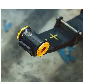 A close up of a black and yellow Old Man Emu handlebar with a shock absorber.