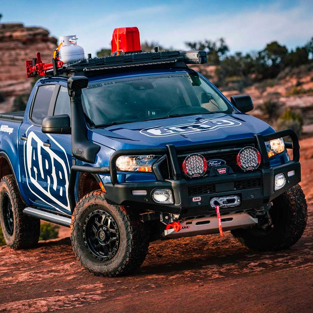 The Toyota Land Cruiser 150 Series, 4Runner, FJCruiser Old Man Emu, equipped with an impressive 4X4 suspension and OME Shock Stone Guard Kit OME661 Sport Shocks, confidently rests on a rocky cliff.