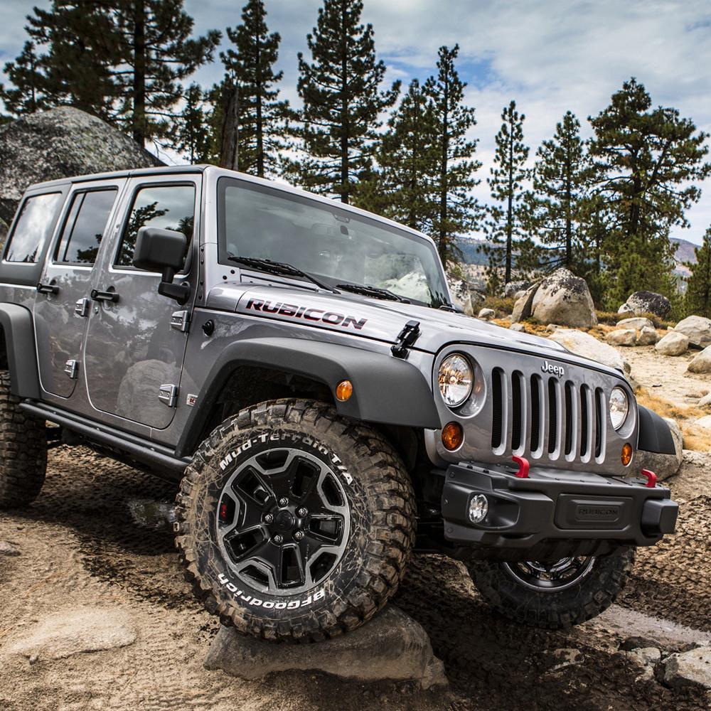The 2014 ARB jeep wrangler, equipped with an ARB RD104 Air Locker Differential Dana 30 with 30 Splines, is driving on rocky terrain with quiet operation.