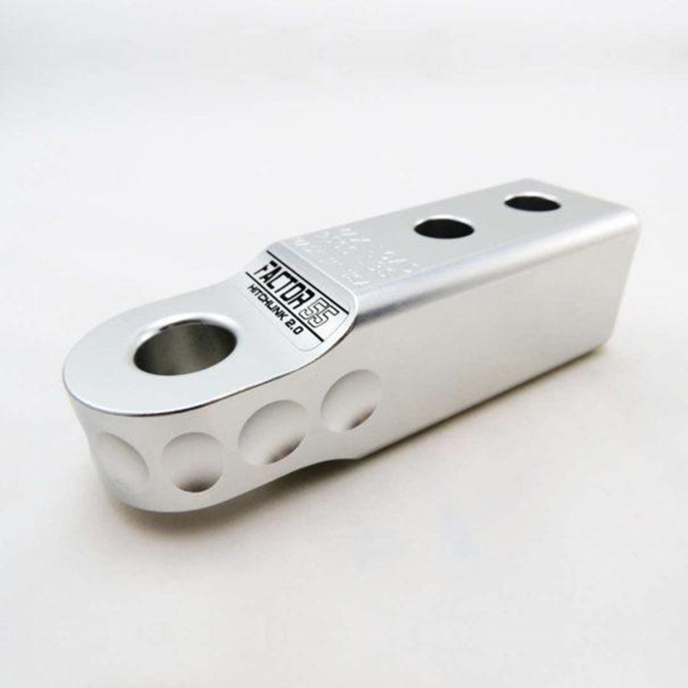 A Factor 55 HitchLink 2.0in Silver 00020-05 stainless steel bracket with a powder coated finish on a white surface.