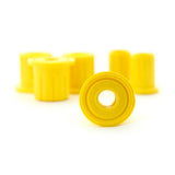 Yellow Old Man Emu leaf spring bushings on a white background enhance suspension performance.