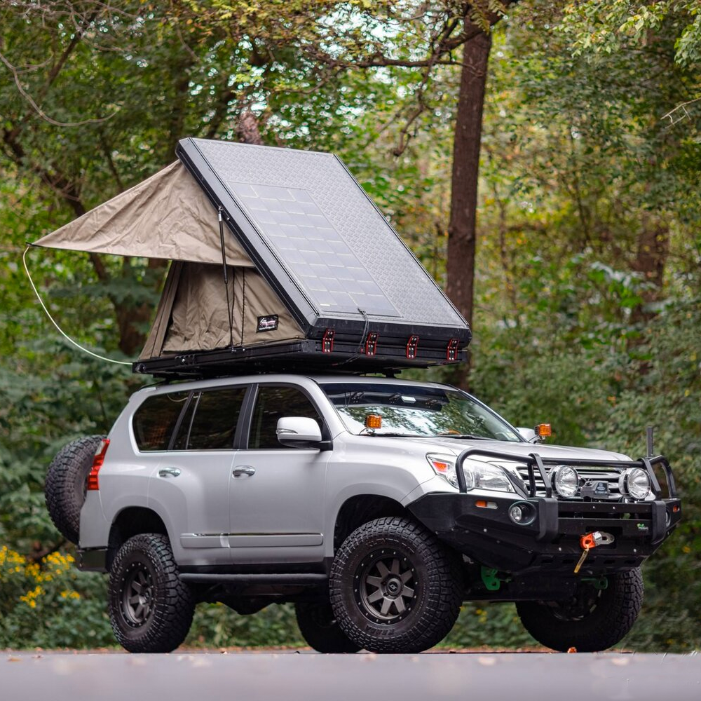 A MetalTech GX460 suv with a tent on top of it.