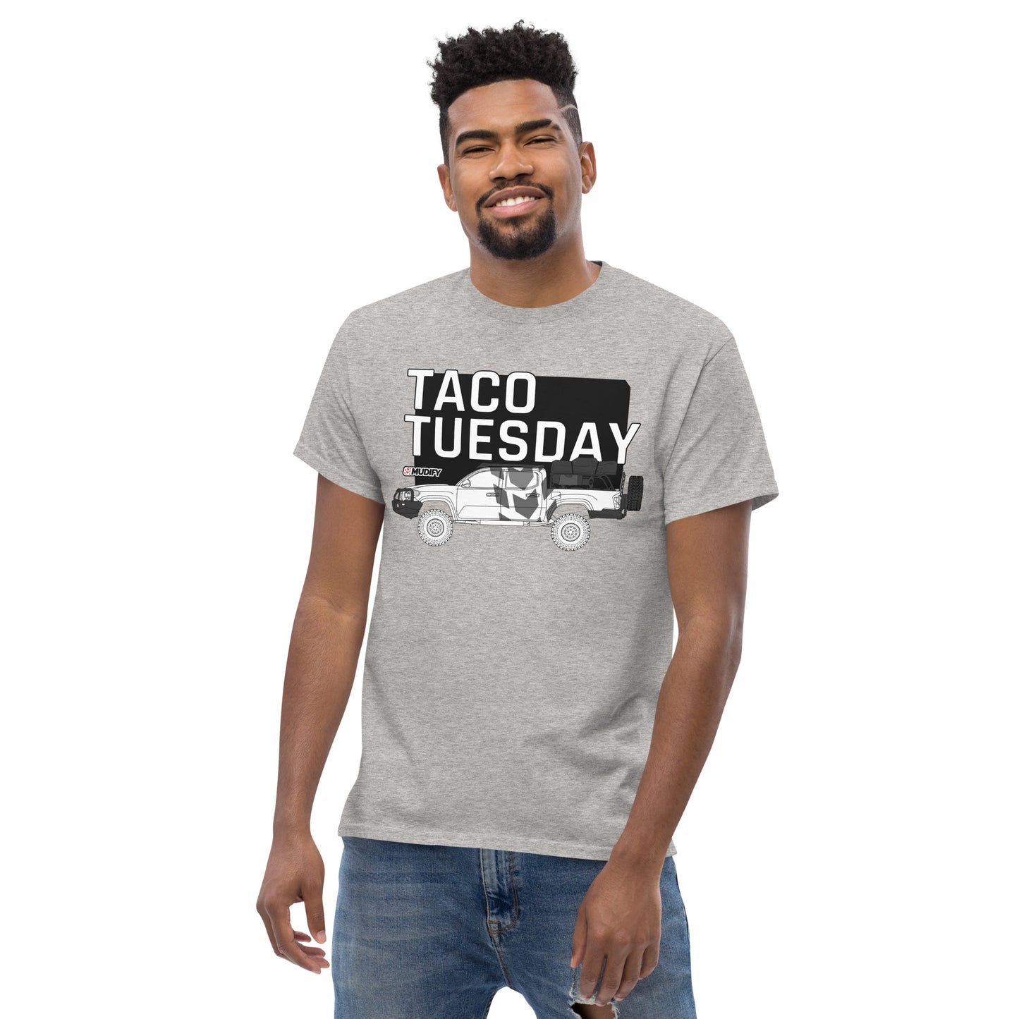 A man wearing a streetwear outfit, with a Mudify Taco Tuesday Tee made of 100% cotton.