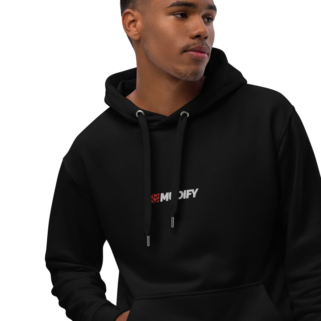 A man wearing a Mudify Premium Eco Hoodie made with organic and recycled materials.