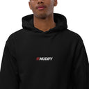 A man wearing a Mudify Premium Eco Hoodie with the word muddy on it, made from organic and recycled materials for a comfortable fit.