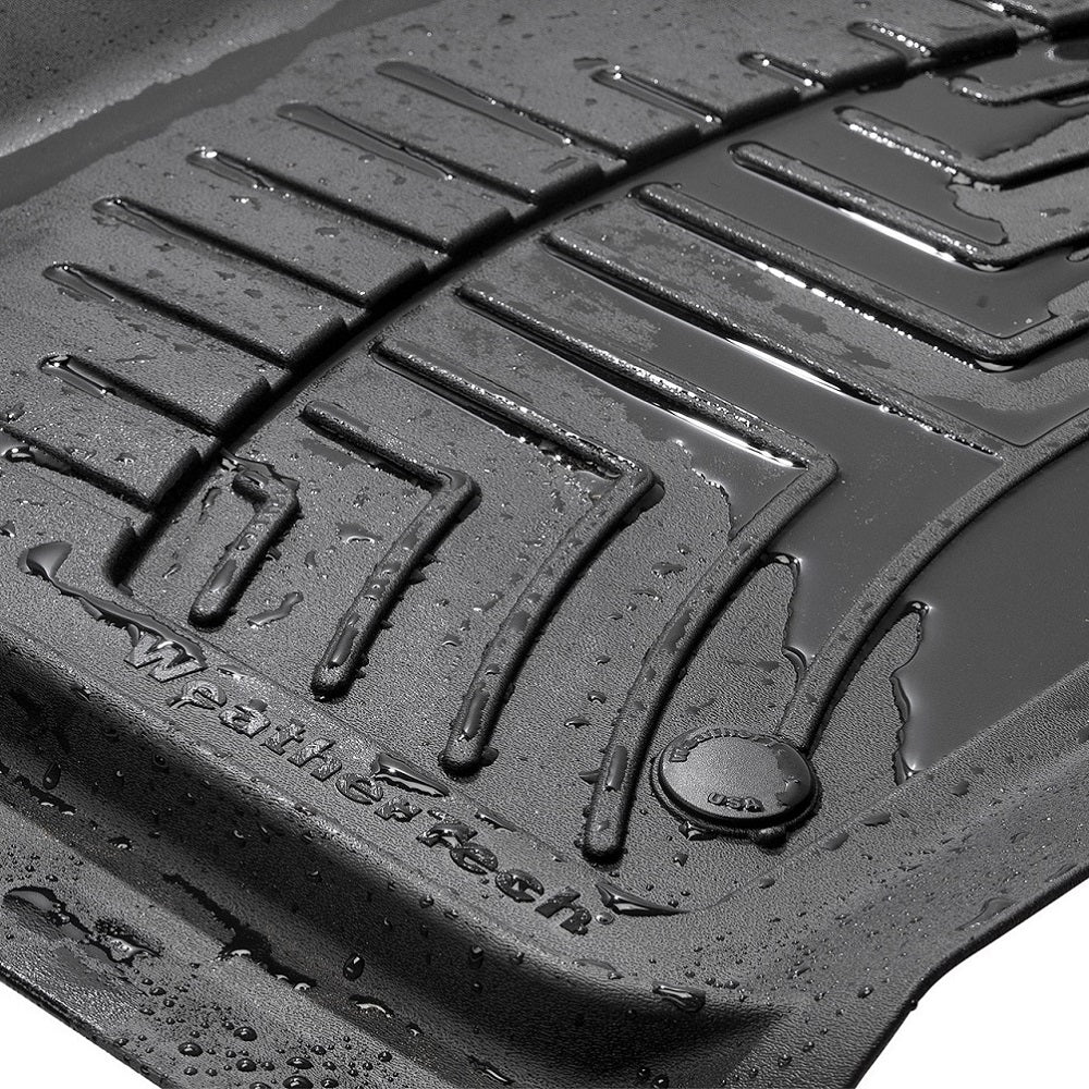A Weathertech Floorliner HP 1st Row Floor Mats for Toyota 4Runner (2013-2023) with water on it, providing interior protection.